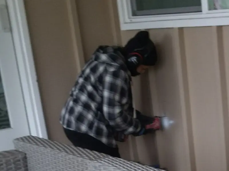 Professional electrician installing an exterior outlet in Tigard